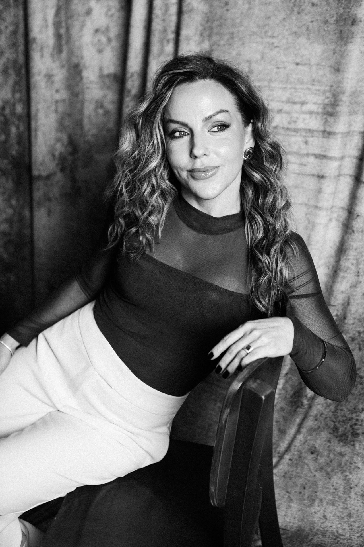 Susana Santin sentada em retrato corporativo preto e branco